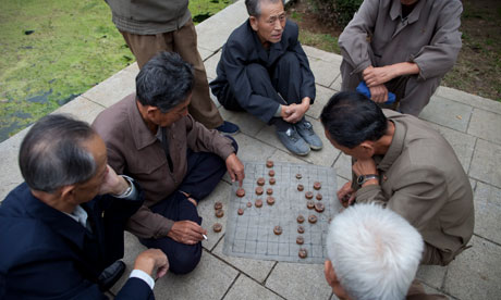 Old men play Korean Chess near the Party Foundation Monunment in Pyongyang. Old men play Korean Chess in Pyongyang. Photograph: Dan Chung/Guardian
