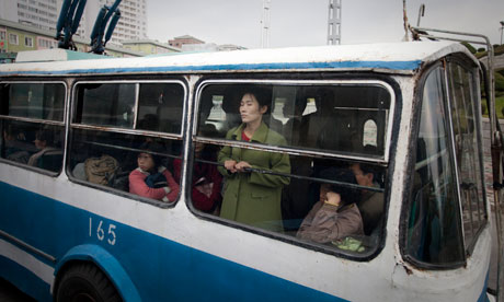 Tired commuters cross Pyongyang on an old bus. Photograph: Dan Chung/Guardian 
